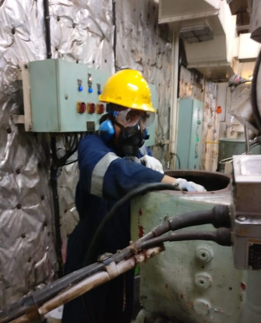 woman marine engineer working on ship engine room