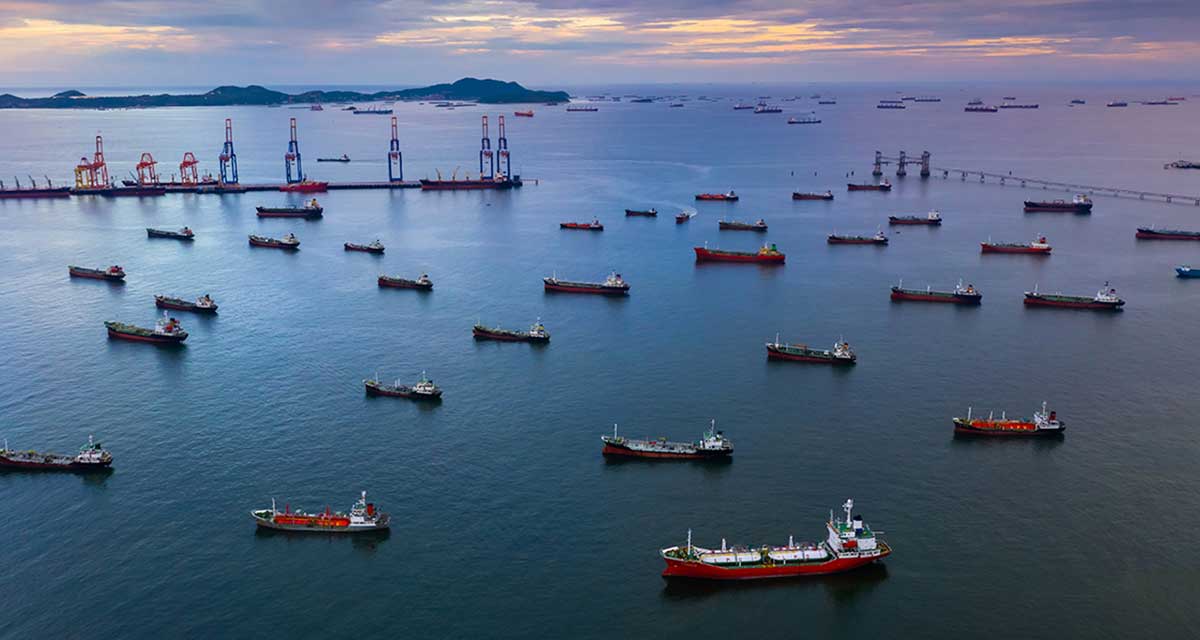 Aerial view of dense rows of various vessels on the waters of Singapore.
