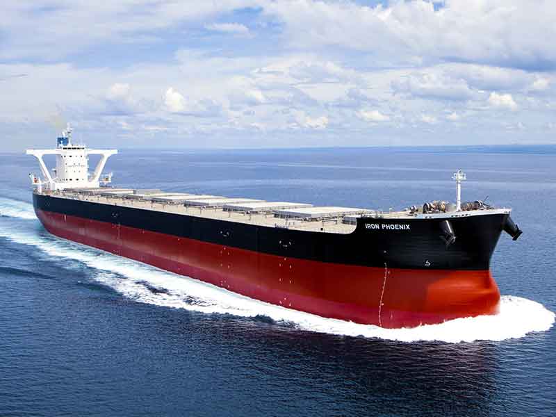 The bulk carrier ship &ldquo;Iron Phoenix&rdquo; sails at sea, showcasing its sleek black and red hull while promoting sustainable marine biofuel usage