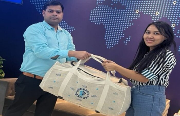 Synergy Marine Group employees exchanging a HASA eco-friendly juco bag handcrafted by women artisans in Odisha