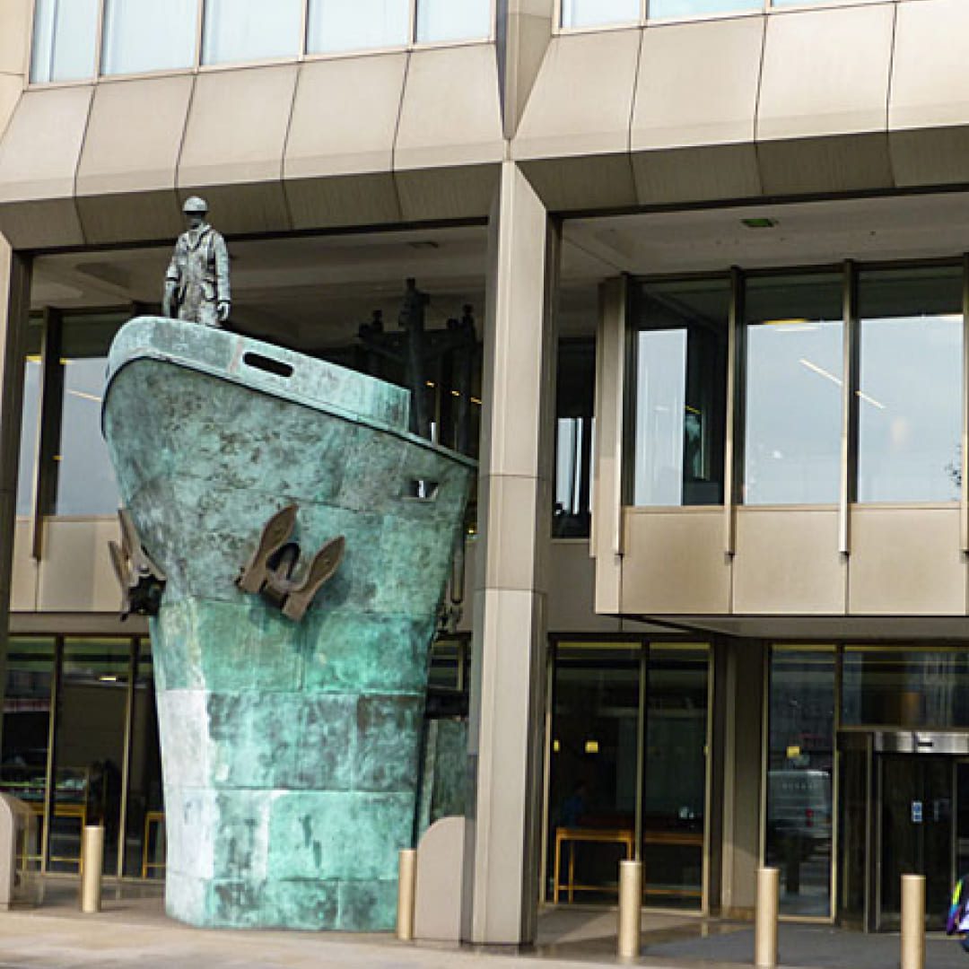 Bronze seafarer memorial statue on a ship's bow outside the International Maritime Organization (IMO) building headquarters in London.