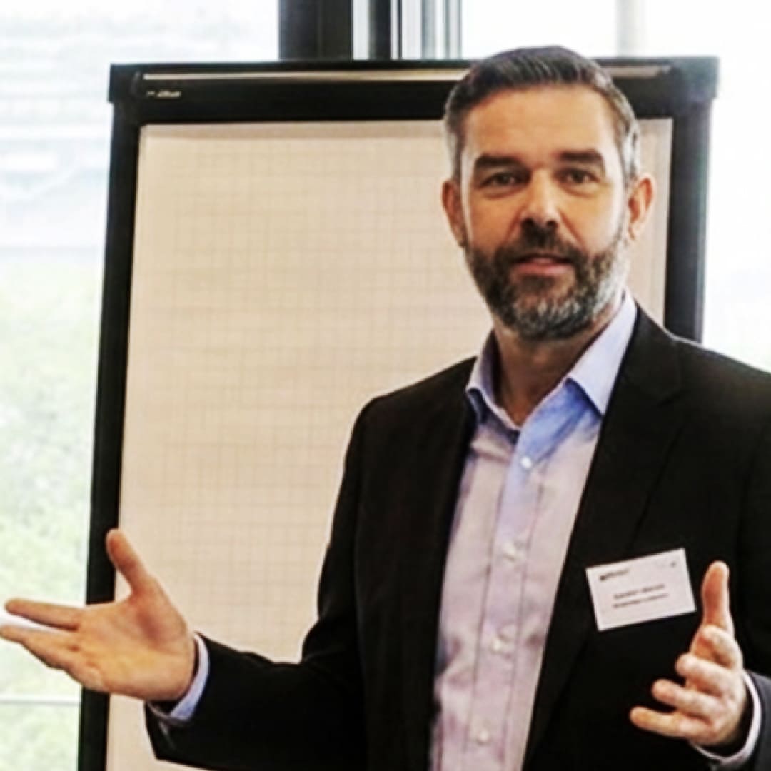 Nikolaj von Wartburg Head of Europe Synergy Marine Group, speaking beside a white presentation board.