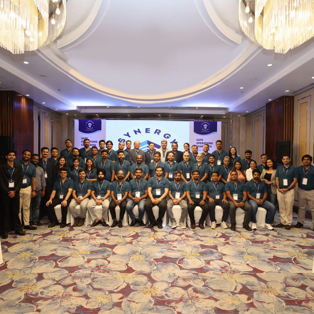 Group photo of attendees at the Synergy Onyx Crew Safety Seminar in a conference hall.