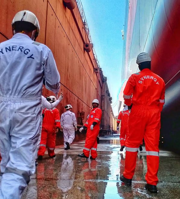 Synergy Marine Group engineers inspecting vessel hull inside dry dock facility