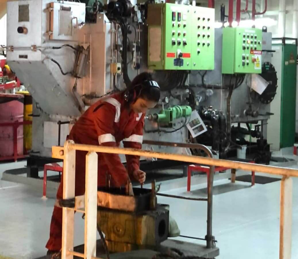 Engine Cadet Anushka Rudola working on marine machinery inside the ship&rsquo;s engine room, demonstrating technical skills and focus during maintenance operations.