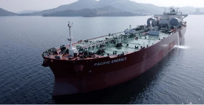 Aerial view of YM Willpower, a 15,500 TEU LNG dual-fuel container vessel operating at sea.